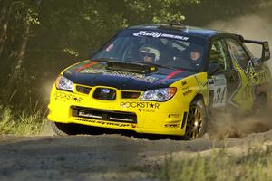 Tanner Foust / Chrissie Beavis Subaru WRX STi rockets out of the woods and past the spectator point on SS13.
