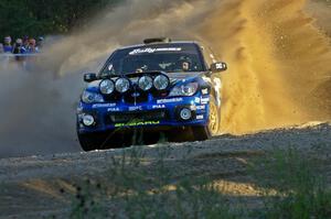 Ken Block / Alex Gelsomino Subaru WRX STi throws a wave of gravel at the SS13 spectator point.