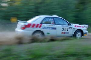 Dave Hintz / John Dillon Subaru WRX prepares to go back into the woods from the county road at the spectator point on SS13.