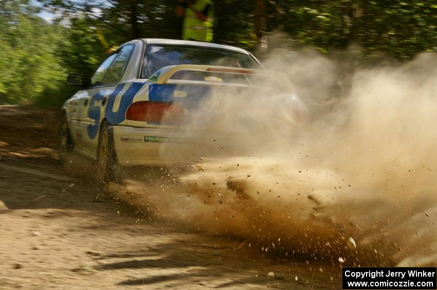 Henry Krolikowski / Cindy Krolikowski Subaru Impreza slings gravel at a 90-right on SS12.