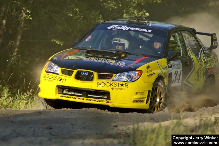 Tanner Foust / Chrissie Beavis Subaru WRX STi rockets out of the woods and past the spectator point on SS13.