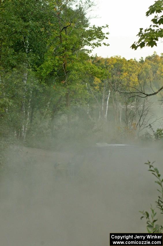 Tanner Foust / Chrissie Beavis Subaru WRX STi leave a trail of dust behind them as they rocket downhill on SS15.