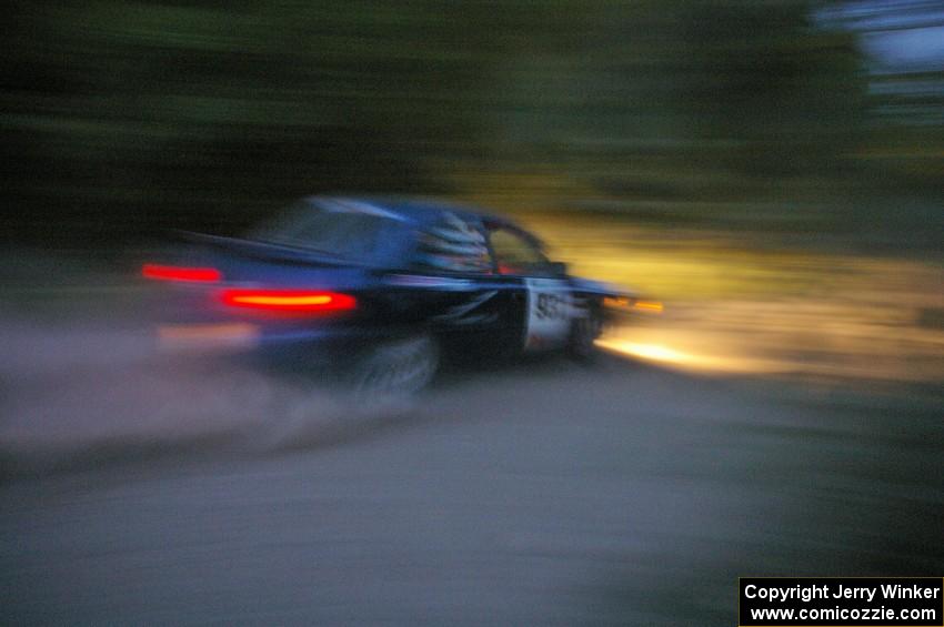 Don Kennedy / Matt Kennedy Subaru Impreza at speed on SS15 just after sundown.