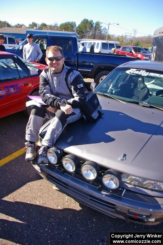 Jason Grahn sits on the hood of the Evan Cline Mitsubishi Galant VR4 at parc expose in Houghton.