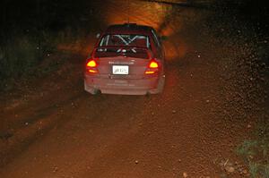 Dennis Martin / Kim DeMotte Mitsubishi Lancer Evo IV goes sideways uphill at the final corner of Echo Lake 1, SS4.