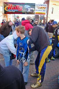 Travis Pastrana signs an autograph on the back of a young fan at parc expose in Calumet on Saturday of the event.