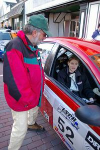 Jimmy Brandt has a morning chat with Karen Wagner seated in the navigator seat of the Doug Shepherd Dodge SRT-4.