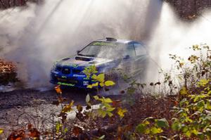 Travis Pastrana / Christian Edstrom Subaru Impreza WRX hit a large puddle near the end of Gratiot Lake 1, SS9.