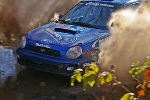 Travis Hanson / Terry Hanson Subaru WRX hit the puddle two miles from the end of Gratiot Lake 1, SS9, at speed.
