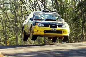 Andy Pinker / Robbie Durant Subaru Impreza WRX at the midpoint jump on Brockway 1, SS13.