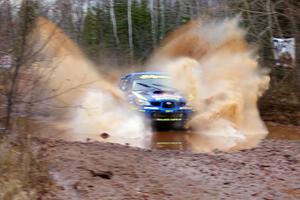 Travis Pastrana / Christian Edstrom Subaru Impreza WRX hit a puddle near the finish of Gratiot Lake 2, SS16, at speed.