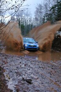Travis Hanson / Terry Hanson Subaru WRX hit the puddle at the end of Gratiot Lake 2, SS16, at speed.