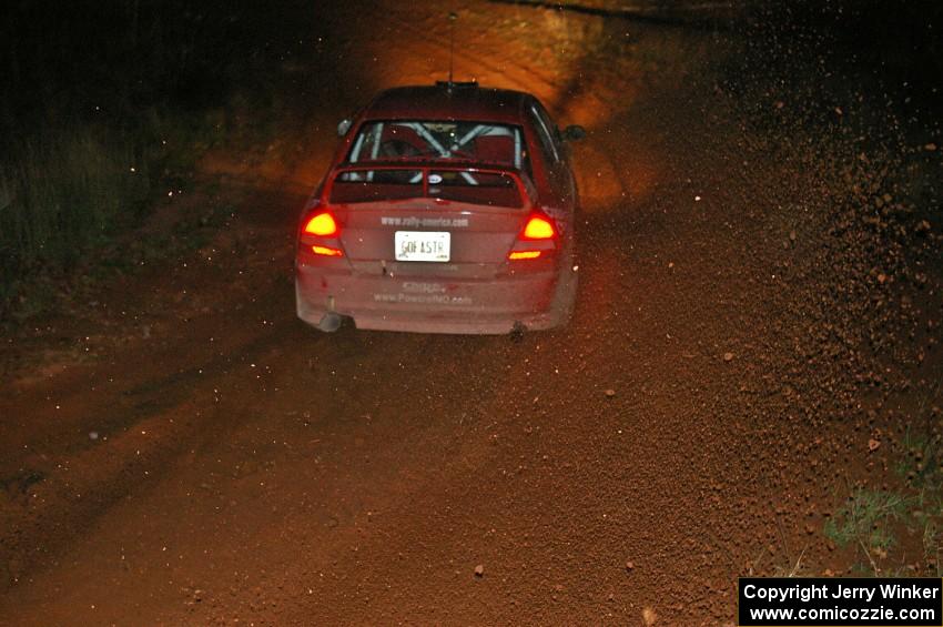 Dennis Martin / Kim DeMotte Mitsubishi Lancer Evo IV goes sideways uphill at the final corner of Echo Lake 1, SS4.