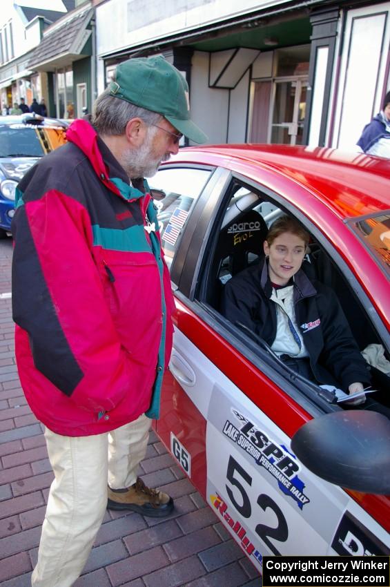 Jimmy Brandt has a morning chat with Karen Wagner seated in the navigator seat of the Doug Shepherd Dodge SRT-4.