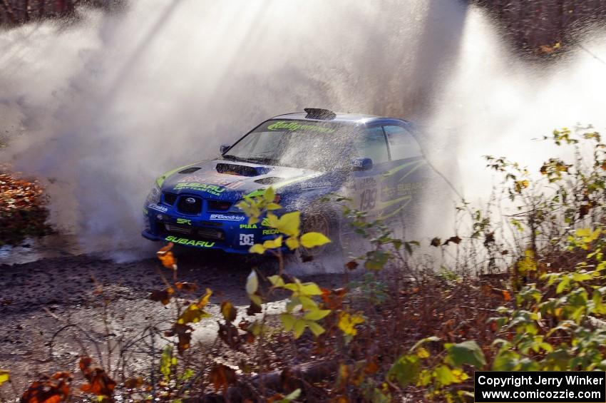 Travis Pastrana / Christian Edstrom Subaru Impreza WRX hit a large puddle near the end of Gratiot Lake 1, SS9.