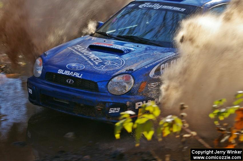 Travis Hanson / Terry Hanson Subaru WRX hit the puddle two miles from the end of Gratiot Lake 1, SS9, at speed.