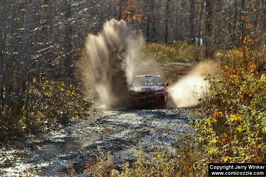 Dennis Martin / Kim DeMotte Mitsubishi Lancer Evo IV hits a puddle near the finish of Gratiot Lake 1, SS9.