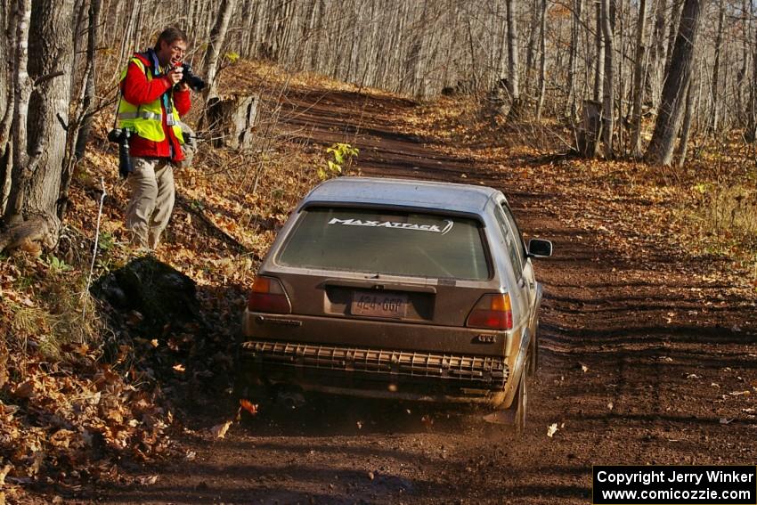 Dave Cizmas / Matt Himes VW GTI blast through a corner on Gratiot Lake 1, SS9, while Ken Friberg takes a shot.