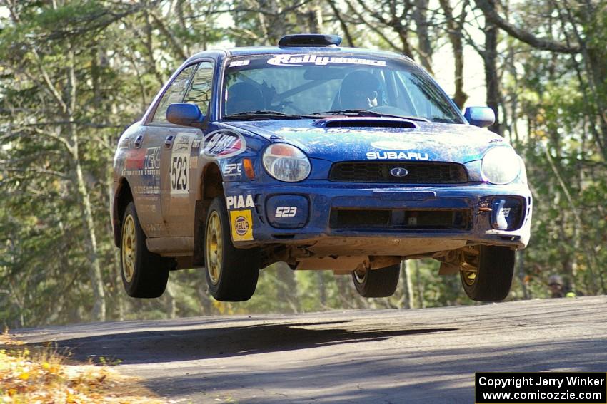 Travis Hanson / Terry Hanson Subaru WRX get nice air at the midpoint jump on Brockway Mountain, SS13.