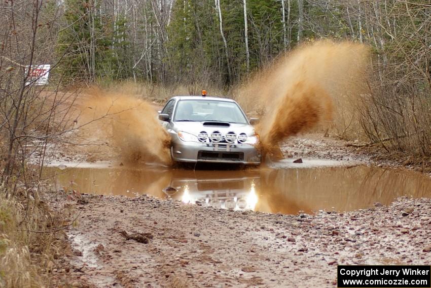 The O car of Tom Nelson hits a puddle near the finish of Gratiot Lake 2, SS16, at speed.