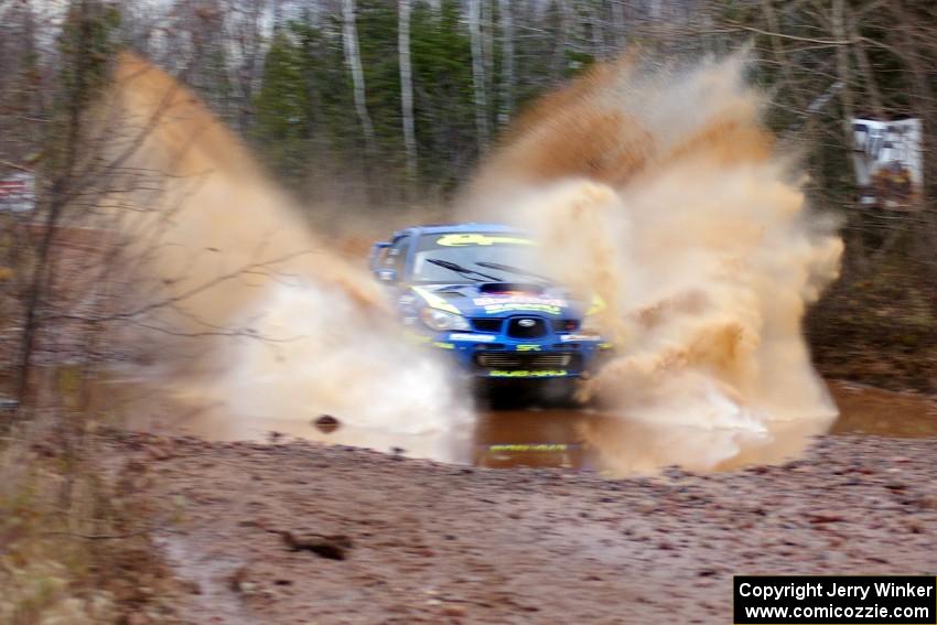 Travis Pastrana / Christian Edstrom Subaru Impreza WRX hit a puddle near the finish of Gratiot Lake 2, SS16, at speed.