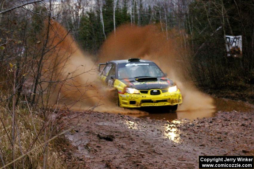 Tanner Foust / Chrissie Beavis Subaru WRX through the final puddle on Gratiot Lake 2, SS16.