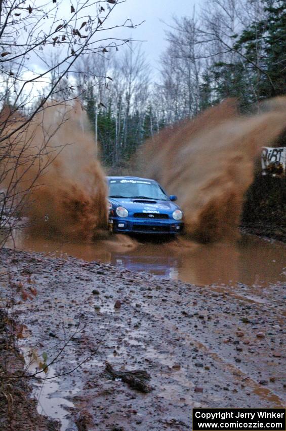 Travis Hanson / Terry Hanson Subaru WRX hit the puddle at the end of Gratiot Lake 2, SS16, at speed.