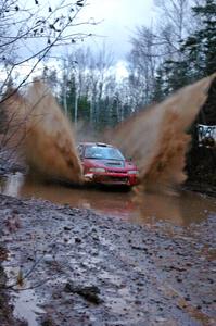 Dennis Martin / Kim DeMotte Mitsubishi Lancer Evo 4 hits the final big puddle on Gratiot Lake 2, SS16, at speed.