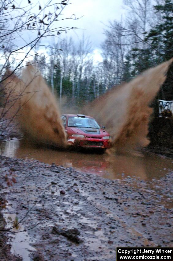 Dennis Martin / Kim DeMotte Mitsubishi Lancer Evo 4 hits the final big puddle on Gratiot Lake 2, SS16, at speed.