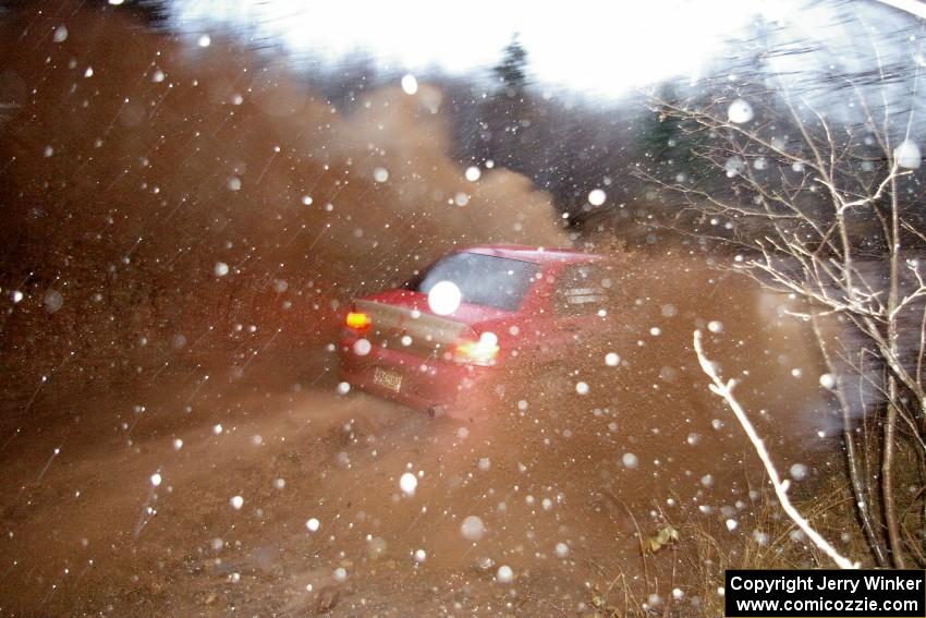 Amy BeberVanzo / Alex Kihurani Mitsubishi Lancer Evo 8 through the final puddle on Gratiot Lake 2, SS16.