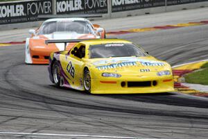 John Schaller's Chevy Camaro ahead of Simon Gregg's Chevy Corvette