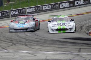 Tomy Drissi's Jaguar XKR gets the inside line in turn five on R.J. Lopez's Chevy Corvette