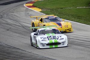 Jim Bradley's Chevy Corvette weaves around the stalled Jaguar XKR of Tomy Drissi