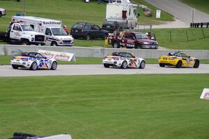 MX-5s head into the carousel on the final lap