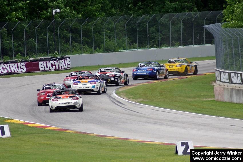 MX-5s at speed through the kink