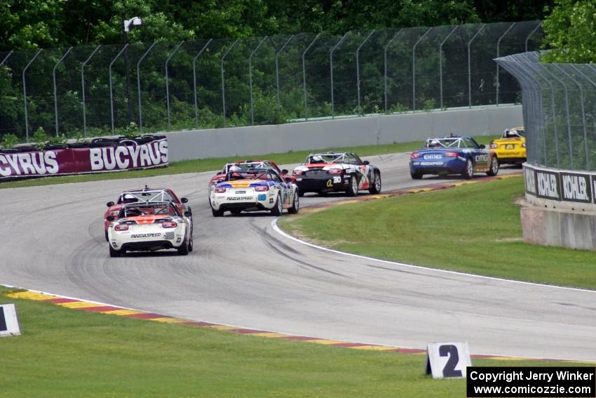 MX-5s at speed through the kink