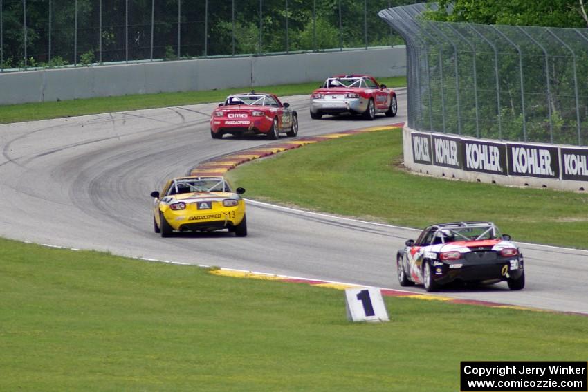 MX-5s at speed through the kink