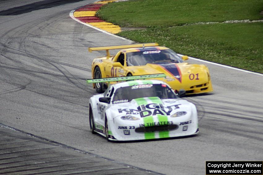 Jim Bradley's Chevy Corvette weaves around the stalled Jaguar XKR of Tomy Drissi