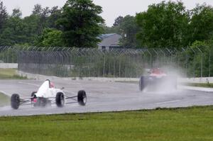 Dave Schaal's Spec Racer Ford and Jeff Bartz's Van Diemen RF00K Formula Ford at turn 6 in the rain