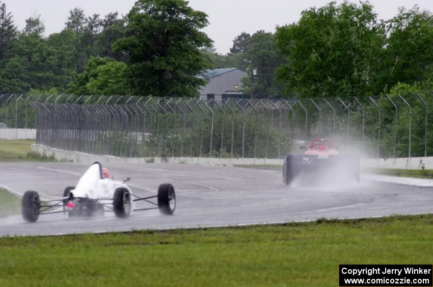 Dave Schaal's Spec Racer Ford and Jeff Bartz's Van Diemen RF00K Formula Ford at turn 6 in the rain