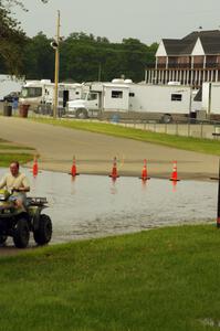A huge puddle at the paddock access road near the front gate