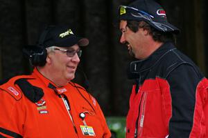 Paul Fox and Jed Copham chat during Saturday morning's rainfall