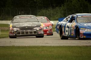 Brett Thompson's Chevy Impala and Dylan Hutchison's Chevy Impala into turn 12