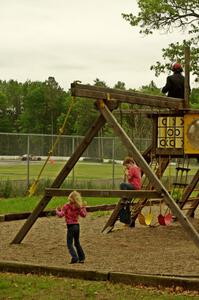 Ronnie Jay's Ford Taurus spins in turn 8 as kids play on the playground