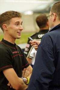 Michael Self is interviewed after winning in his Chevy Impala