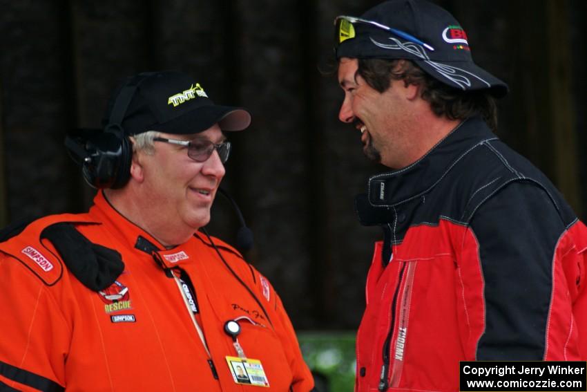 Paul Fox and Jed Copham chat during Saturday morning's rainfall