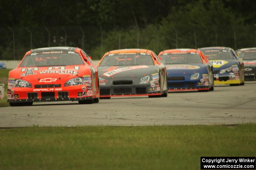 Cars stream into turn 12 during the race