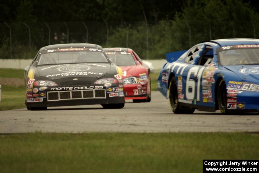 Brett Thompson's Chevy Impala and Dylan Hutchison's Chevy Impala into turn 12