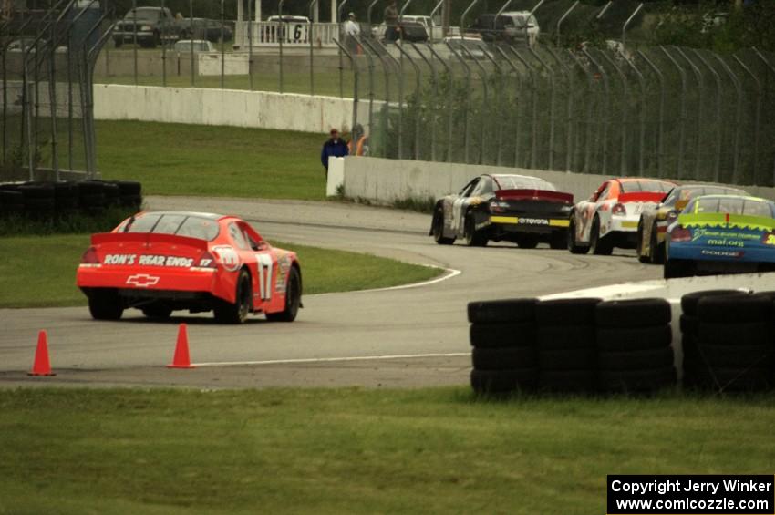 Five cars stream out of turn 10 into 11 late in the race