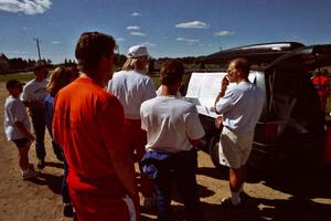 Jim Buchwitz, Al Kintigh, Dave Fuss and others check the scoreboard at service.